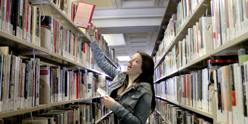 Amanda looking for a book in the Library